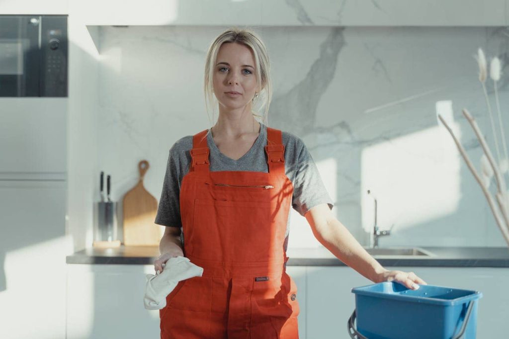 Lady cleaner posing with cleaning equipment in Ashford – professional cleaning service